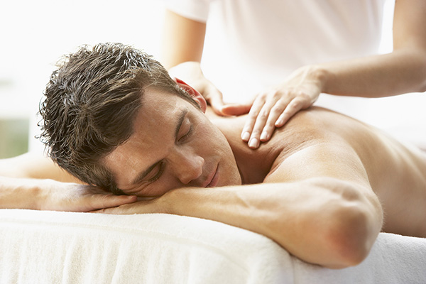 Young Man Enjoying Massage At Spa